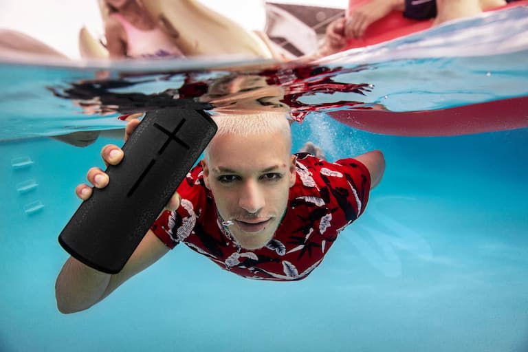 man swimming with ultimate ears speaker underwater